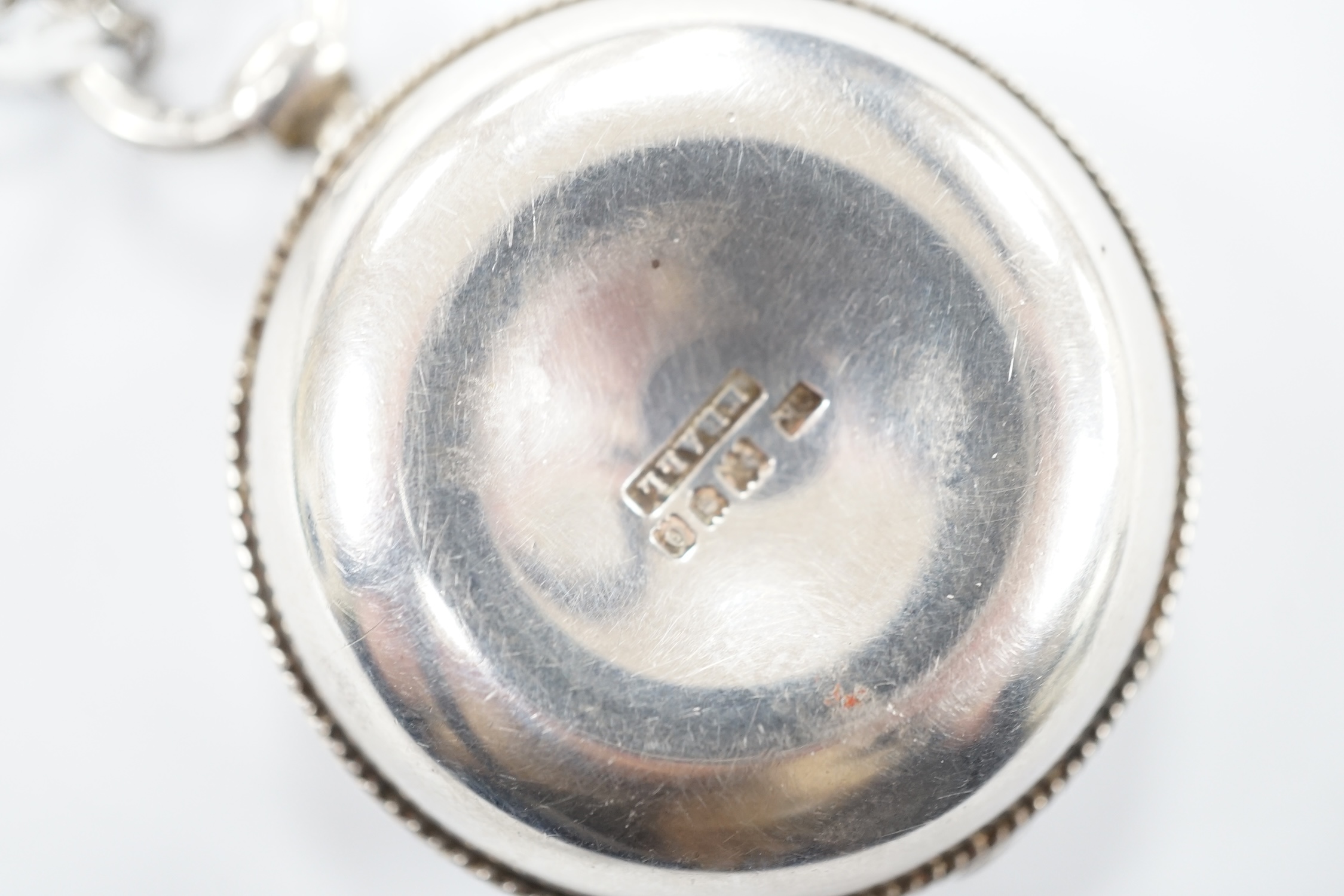 An Edwardian silver circular pyx by Carl Krall, the cover engraved with a bird with new born chicks, London, 1909, diameter 43mm, together with a white metal chain. Good condition